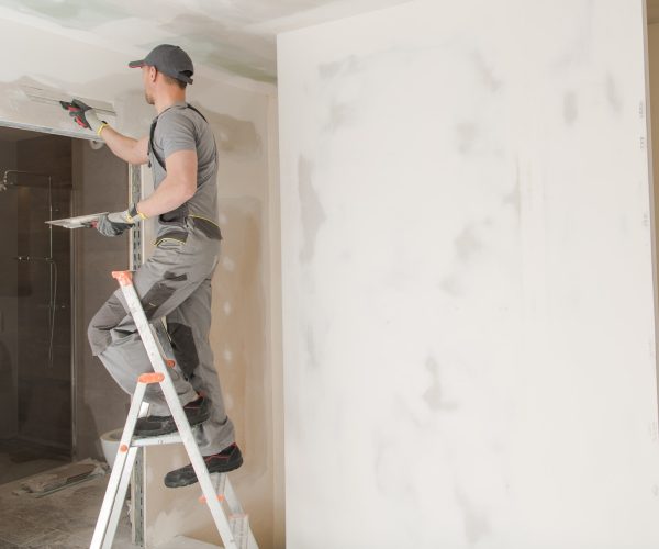 Worker Patching Drywall